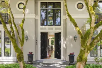 Bienvenue a la maison! Oversized doors & architectural landscaping welcomes you in.
