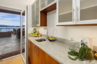 Top floor bar has mirrored rich finishes complementing the kitchen design.