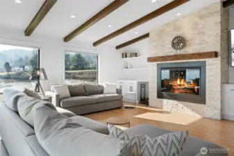 Cozy up to the 52" wood-burning fireplace in the living room, complete with a custom mantel and built-in cabinetry for additional storage.