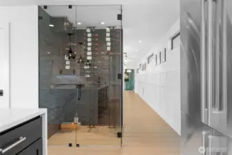 Walk-in wine room off the kitchen with temperature-controlled cooling unit.