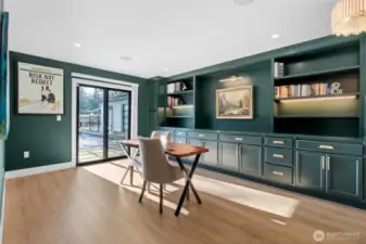 Rich and light-filled office space with custom built-ins and so much space for work or hobbies. You'll want to take every Zoom call from here.