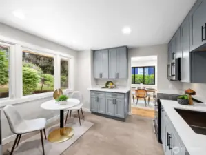 New kitchen with breakfast nook looks out to back yard privacy.