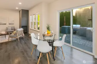 Nook opens up to sliding glass door and back yard patio with BBQ and firepit area