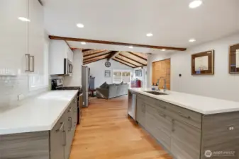 Glass tile backsplash and high-end cabinets with sliding under counter storage are some of the details that set this home apart.