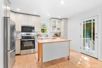 Stylish modern updates in the kitchen and a side door to access the driveway and backyard.