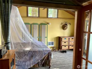Bedroom with deck access and lake views.