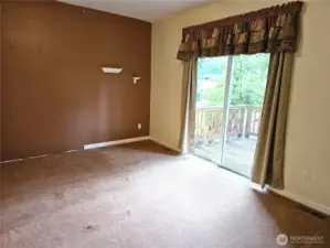 Main bedroom with sliding door out to deck overlooking golf course