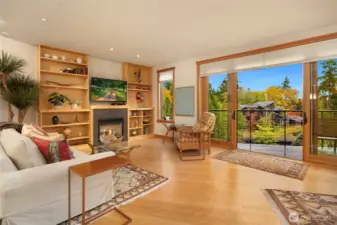 The open floor plan connects the living room, dining area and updated kitchen to the main floor deck. A wall of glass doors and windows brings in exceptional south facing light.