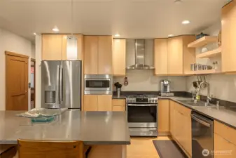 What a great kitchen! New countertops, new appliances, new cabinet fronts of natural wood, with open shelving added to showcase your special pieces.