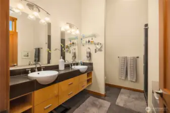 Double sinks and plenty of storage in the primary bath.