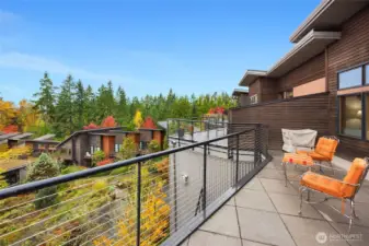 The upper deck is a favorite feature of the owner as sits above the trees for great sun. It over looks the pond and all the courtyard landscaping.  Very private, no walking path passes you by.