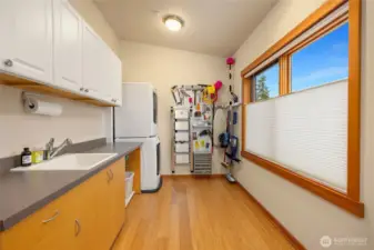 Amazing laundry room is spacious, with natural light, plenty of storage and out of view is extra room where the seller had tables for craft space.