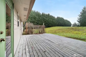 The deck area which has a door to a mechanical room with the furnace and hot water heater.