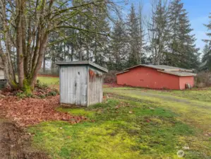 A view of the barn and the pump house for the well.