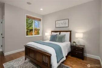 Main level ensuite bedroom with 3/4 bathroom and walk-in closet