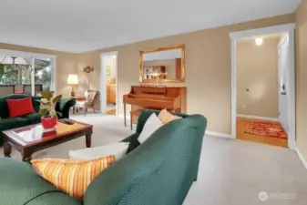 The formal Living room offers lots of natural light from the large windows that look out to the deck.