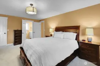 Primary bedroom with walk in closet and 3/4 bath