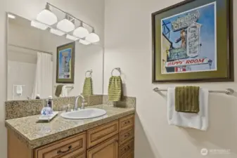 Like the kitchen and other bathrooms in the home, this one features custom cabinetry.