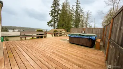 Side porch with benches and hot tub.