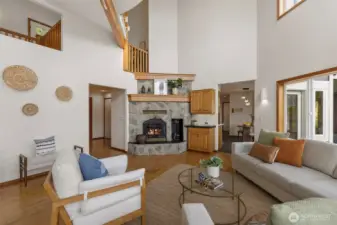 Family room with dedicated office out of shot to left and kitchen/eating nook ahead to right.