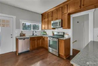 Newer kitchen with full, extra high custom maple cabinetry, quartz countertops, and brand new subway tile backsplash!