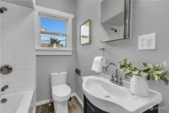 Completely remodeled main floor bathroom with new tub, new tile tub surround, new plumbing, new vinyly plank flooring, new vanity, sink & faucet, and new toilet!! Very nice!