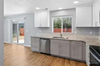 Easy access to the backyard through the large sliding doors paired with the large kitchen window over the sink providing more natural light throughout.