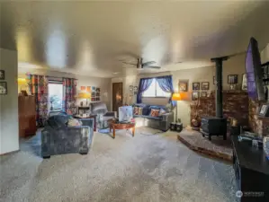 Spacious family room with wood stove, 3/4 bath and access to the side and back yards.