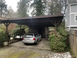 There is a large carport large enough for two cars.