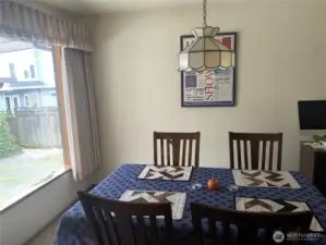 Dining area off the kitchen with a serene view of the backyard.