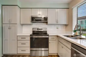 Beautifully upgraded kitchen with newer appliances, counters, tile and custom cabinets!