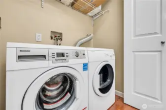 Dedicated laundry area with shelving.