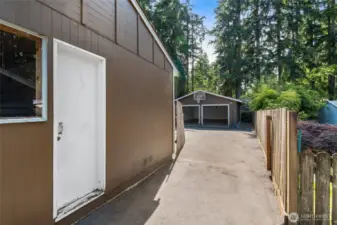Handy side access leads directly to the backyard, detached garage, and shop—ideal for projects, storage, or easy outdoor access.