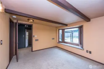 Master suite has exposed beams, updated lighting,bay window to enjoy, full room length closet.