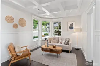 A welcoming flex room off the entry offers a cozy spot for morning coffee, reading, or quiet reflection.