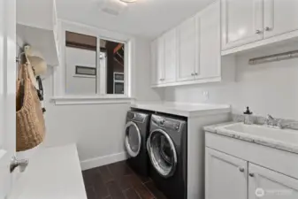 Thoughtfully designed, the main floor features a large laundry room - one of three throughout the home.