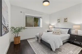 Enjoy ample storage and warmth in the lower-level bedroom, featuring generous closets and radiant heating.