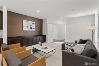 The lower-level bonus/media room is ideal for game nights or movie marathons, complete with built-ins and a beverage fridge.