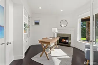 A lower-level office with a fireplace and sweeping views offers versatility - ideal for working, relaxing, or transforming into a bedroom or workout space.