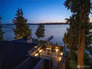 The rooftop deck offers front-row views of vibrant sunsets, the Seattle skyline, and the Olympic Mountains.