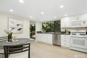 Huge kitchen with freshly painted cabinets and new flooring.