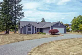 Front of house, has a circular driveway