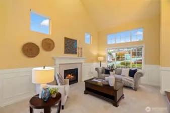 Living room with soaring ceilings and gas fireplace.