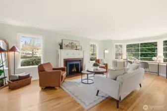 A spacious living room rich in character, warmth, and historic charm.