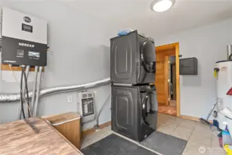 Utility room. Smart solar system to the left. Propane utilities, Washer and dryer(supplemented by solar) and hot water heater .