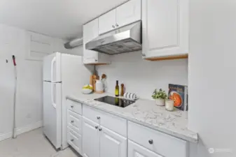 2nd kitchen has a beautiful stainless steel hood and a two burner electric cooktop.  Loads of counter space for prepping and a full size refrigerator.