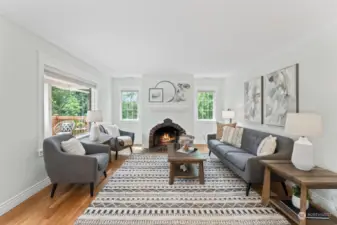 Look at that fireplace!  Such a spacious yet cozy room to curl up with a book or entertain friends.  Big picture windows looks onto the sunny, front deck.