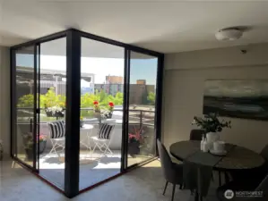 The balcony has two entries one on left and the other on the right side near the dining area.