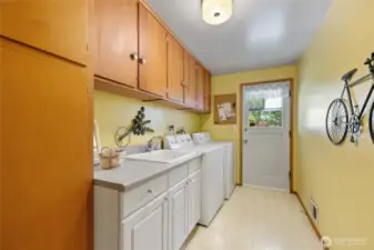 Laundry room with door to back yard