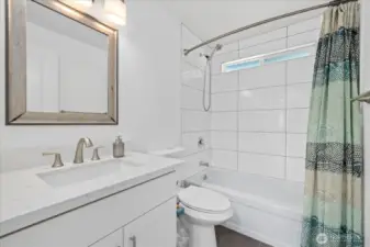 Elegant Tile Bath/Shower Combo Paired with an updated vanity offering plenty of storage solutions!
